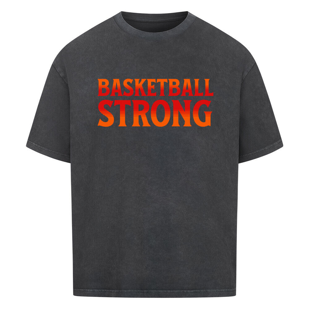 Washed Schwarzes Oversized Basketball T-Shirt mit dem Print „BASKETBALL STRONG“ in einer ikonischen, rot-orangen Retro-Schriftart. Aus 100% Baumwolle.